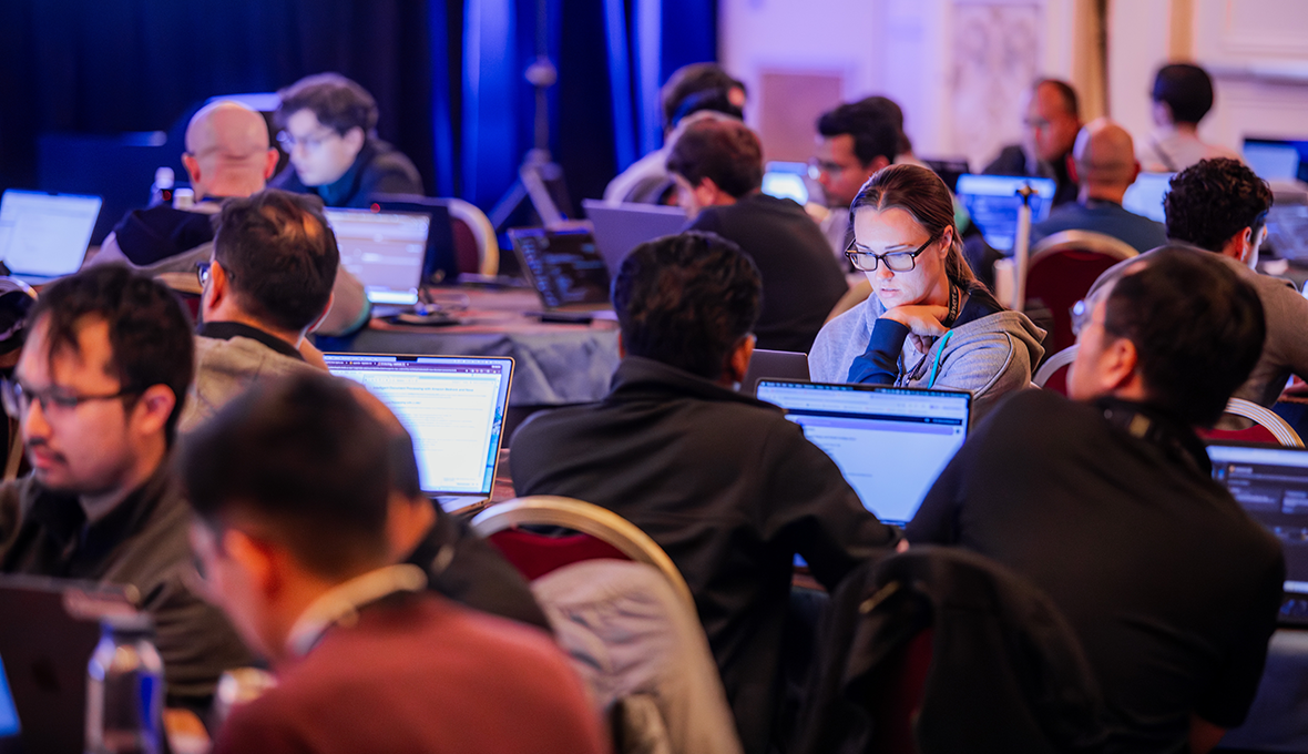 People gathered in from of their laptops at a workshop event