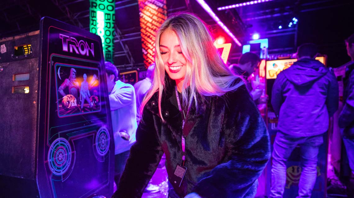 A woman playing a TRON game