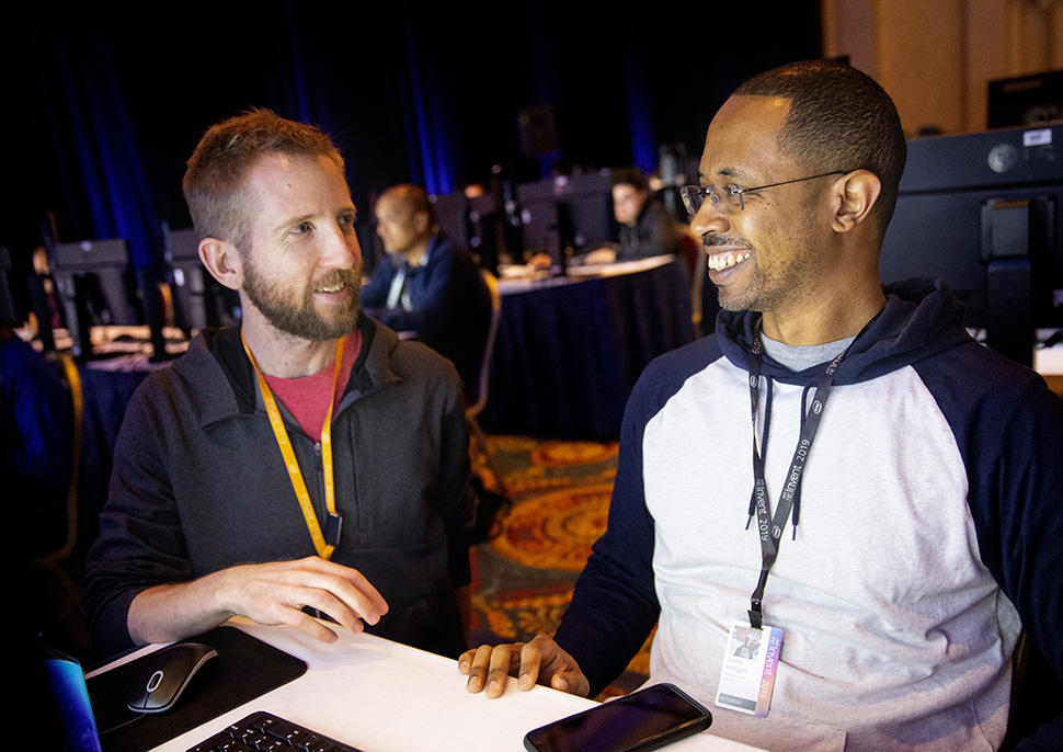 Two men at re:Invent having a discussison.
